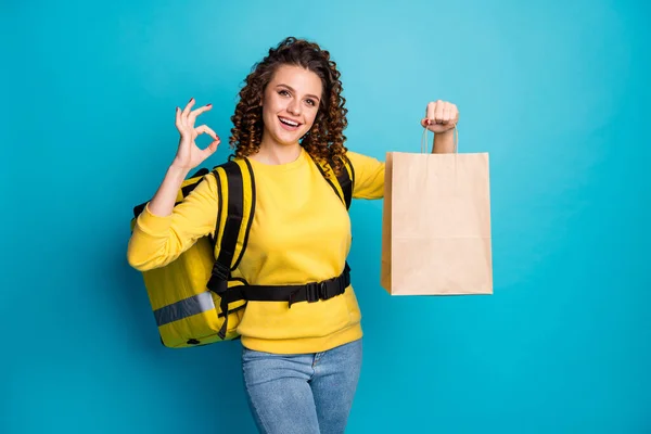 Portrait of her she nice attractive pretty glad cheerful cheery wavy-haired girl bringing takeaway lunch sushi package showing ok-sign isolated on bright vivid shine vibrant blue color background