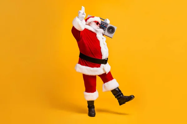 Full length photo of fat cool Santa Claus with beard listen boom box showing two fingers wear sunglass headwear cap isolated over bright shine color background — Zdjęcie stockowe