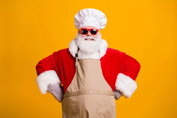 Photo of santa role grandpa grey beard take order waiter cher headwear own business cafe meet guests visitors wear red costume coat gloves sun specs cap apron isolated yellow color background — Stock Photo, Image