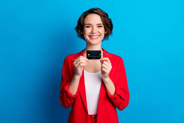 Retrato de atractiva dama alegre alegre demostrando tarjeta bancaria inalámbrico sueldo pase aislado sobre fondo de color azul brillante —  Fotos de Stock