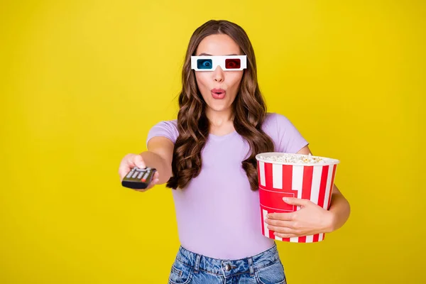 Portrait of attractive amazed funky wavy-haired girl holding corn watching thriller switching channel isolated on bright yellow color background — Stock Photo, Image
