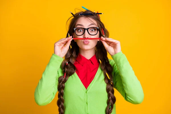 Photo of geek girl messy haircut put pencil nose lips isolated yellow color background — Stock Photo, Image