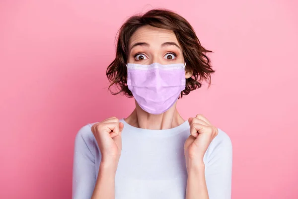 Portrait of girl win lucky gift raise fists scream wear flu mask good look pullover isolated over pink color background