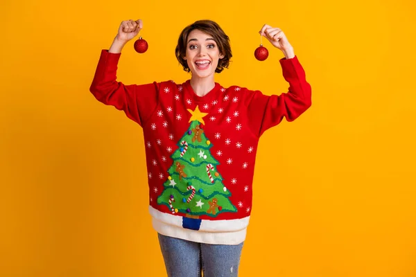 Photo of positive excited girl hold x-mas tradition christmas tree toys baubles wear theme party sweater jumper denim jeans isolated over bright shine color background — Stock Photo, Image
