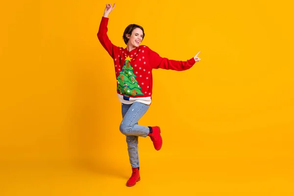 Foto em tamanho completo de positivo alegre menina dança x-mas newyear festa desgaste Natal árvore decoração camisola botas ganga isolado sobre brilhante brilho cor amarela fundo — Fotografia de Stock