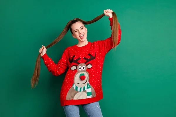 Portrait of her she nice-looking attractive pretty lovely cheerful cheery ecstatic long-haired girl dancing having fun holding ponytails isolated over green color background — Stock Photo, Image