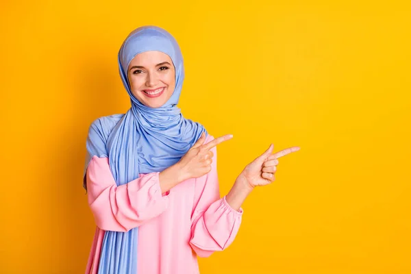 Retrato de muslimah alegre atraente vestindo hijab demonstrando anúncio espaço de cópia isolado no fundo de cor amarelo brilhante — Fotografia de Stock