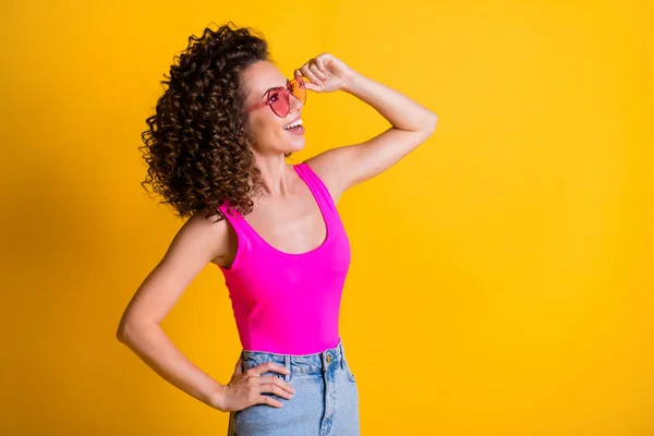 Profile side view portrait of her she attractive gorgeous cheerful cheery wavy-haired girl touching specs enjoying good day mood weather isolated bright vivid shine vibrant yellow color background — Stock Photo, Image