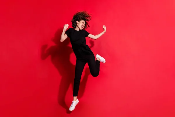 Photo portrait full body view of crazy girl dancing jumping up isolated on vivid red colored background — Stock Photo, Image