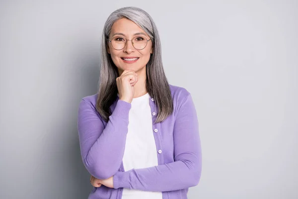 Portrait photo of smart elder intelligent female professor in the university wearing eyeglasses smiling touching face isolated on grey color background — Stock Photo, Image