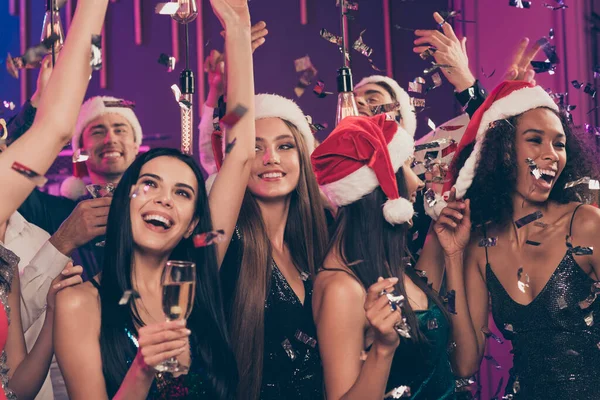 Фото недбалих людей вечірка дівчина тримає скляне золоте вино, маючи веселе вбрання стильний одяг Санта-Клаус шапка сучасного клубу в приміщенні — стокове фото