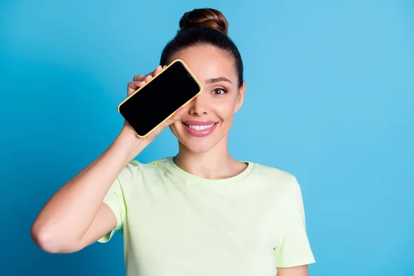 Close-up portrait of her she nice attractive charming cheerful funky girl holding in hand device closing eye new product gadget isolated bright vivid shine vibrant blue color background — Stock Photo, Image