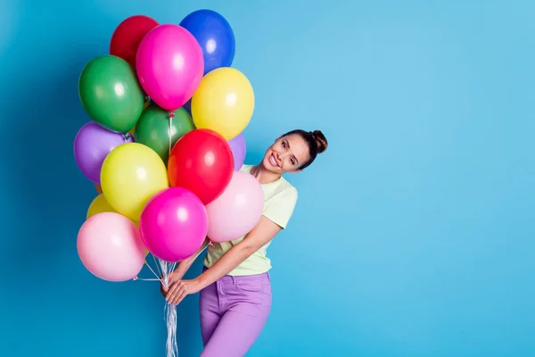 Foto portrét hezké dívky drží hromadu barevných vzduchových balónků s úsměvem na sobě ležérní oblečení izolované na jasně modré barvy pozadí — Stock fotografie