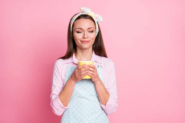 Portrait of positive cheerful girl hold caffeine beverage mug smell aroma wear shirt isolated over pastel color background — Stock Photo, Image