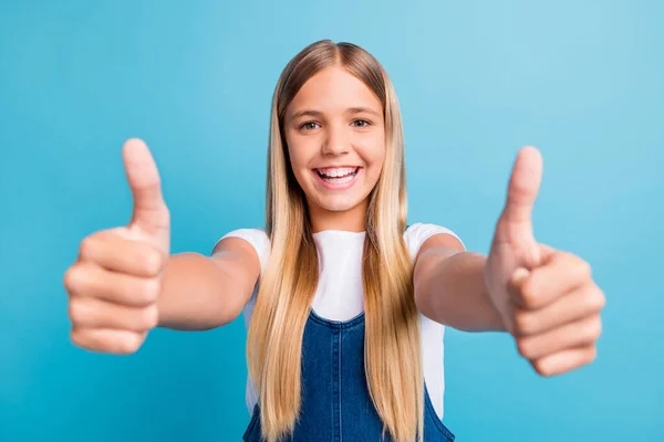 Närbild foto av ganska optimistisk tonåring blond långt hår flicka tummen upp bära vit t-shirt isolerad över pastell blå färg bakgrund — Stockfoto