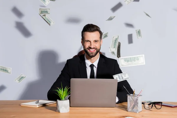 Photo of handsome business guy notebook table bucks american falling toothy smiling rich chief successful startup income wear blazer shirt tie suit sit chair isolated grey background — Stock Photo, Image