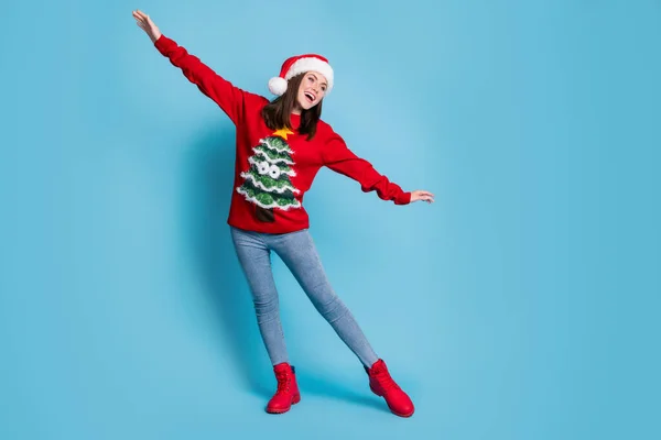 Photo portrait of girl making plane gesture with hands pretending to fly isolated on pastel light blue colored background — Stock Photo, Image