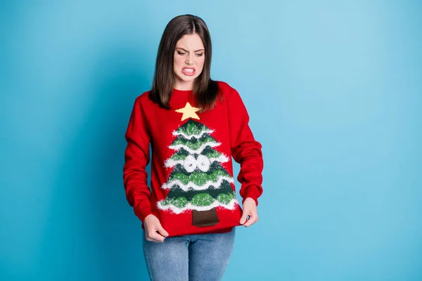 What an uncomfortable pullover. Photo portrait disgusted girl wearing nasty jumper star googly eyes tree pulling with hands isolated on pastel light blue colored background — Stock Photo, Image