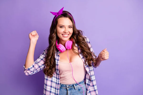 Photo of cute young lady dance having fun wear headphones checkered shirt retro headband isolated violet color background — Stock Photo, Image