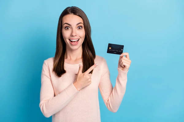 Close-up portrait of her she nice attractive glad cheerful cheery brown-haired girl holding in hands demonstrating bank card cash back isolated on bright vivid shine vibrant blue color background — Stock Photo, Image