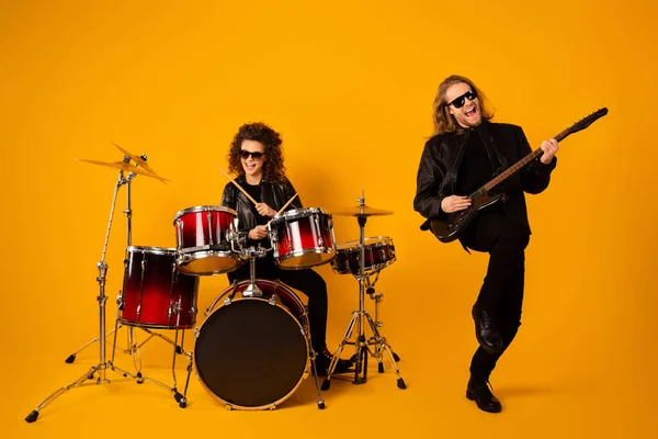 Full length photo of funky rock band girl play drum guy bass guitar enjoy punk tour festival wear black leather boots isolated over bright shine color background