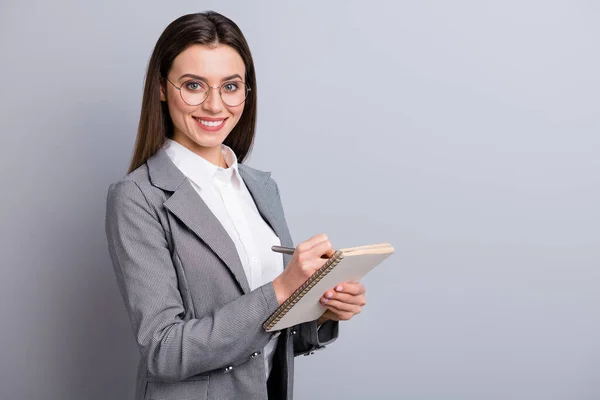 Photo of attractive business lady toothy smile confident manager worker noting writing personal planner interview quotes wear specs shirt checkered blazer isolated grey color background — Stock Photo, Image