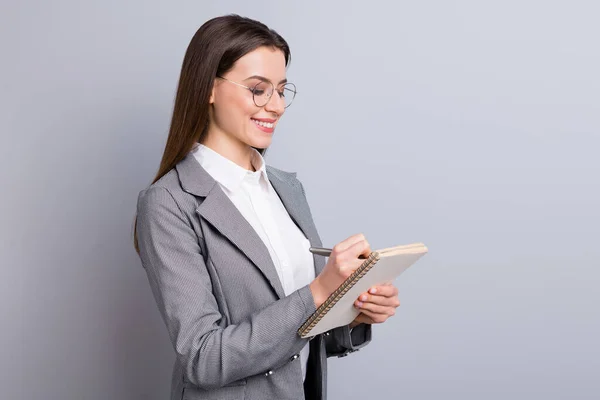 Photo of attractive business lady toothy smile confident manager worker noting writing personal planner interview quotes wear specs shirt checkered blazer isolated grey color background — Stock Photo, Image