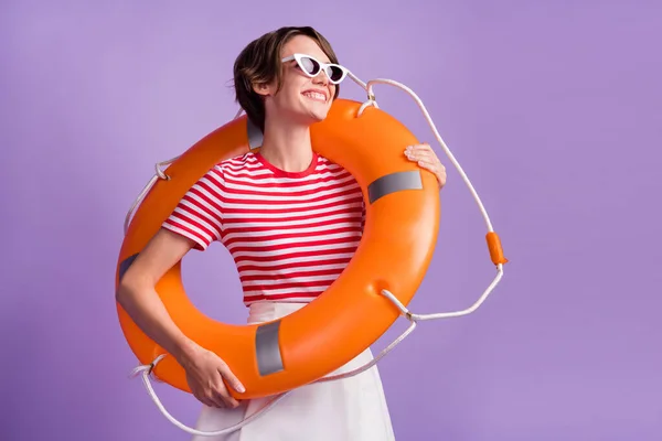 stock image Profile photo of cute lady hold inflatable ring look side wear sunglass striped t-shirt isolated violet color background