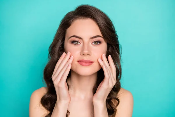 Closeup photo of beautiful cheerful lady curly hairstyle applying daily night cream cheekbones perfect skin spa procedure feel good look mirror nude isolated bright teal color background