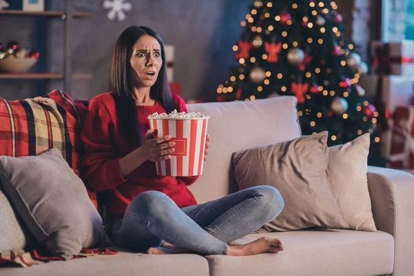 Photo of young beautiful scared shocked afraid woman hold pop corn bucket watch horror film new year eve at home — Stock Photo, Image