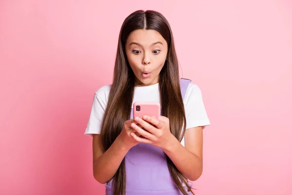 Zdjęcie zdumionego dziecka dziewczyna czytać komentarze sieci społecznościowych smartphone nosić fioletowy biały ogólnie odizolowany na pastelowym tle kolor — Zdjęcie stockowe