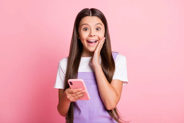 Close-up portrait of her she nice attractive lovely cute charming amazed cheerful cheery long-haired girl using device enjoying having fun isolated over pink pastel color background — Stock Photo, Image