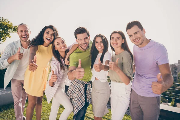 Foto de jovem alegre animado positivo sorrindo bom humor otimista mostrando polegar para cima fora no telhado — Fotografia de Stock