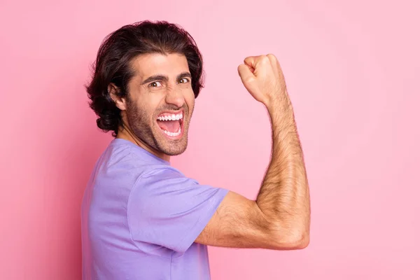 疯狂胡子男人举起手拳头的照片显示肌肉张开嘴穿紫罗兰色衬衫孤立的粉红背景 — 图库照片
