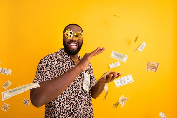 Portrait of his he nice attractive confident handsome bearded funky cheerful cheery guy throwing us dollars million budget isolated on bright vivid shine vibrant yellow color background — Stock Photo, Image