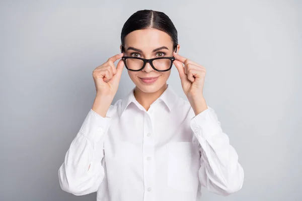 Foto de encantador menina dedos segurar óculos olhar câmera desgaste branco camisa isolado cinza cor fundo — Fotografia de Stock