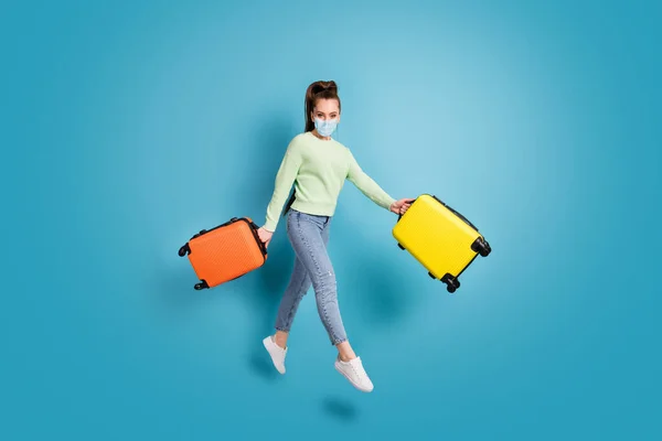 Full body photo of jumping girl keep bags holidays border covid close wear medical isolated blue color background — Stock Photo, Image