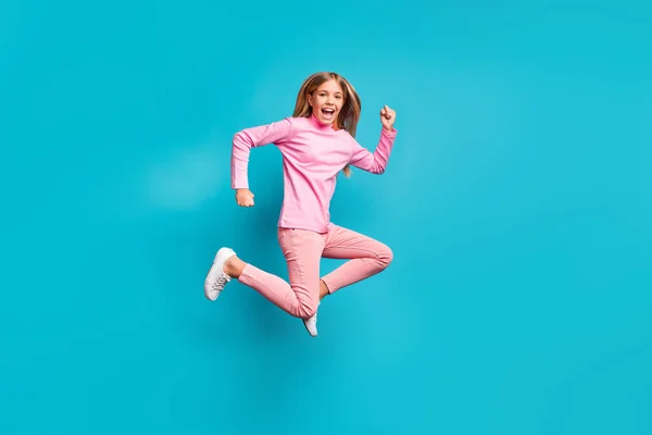 Profile full length photo of nice cheerful teenage girl jump wear pink pants poloneck white shoes isolated on teal background