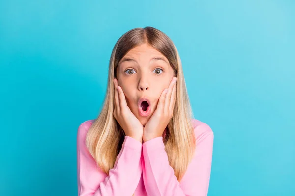 Photo portrait of schoolgirl with blonde hair shouting touching cheeks amazed shocked isolated on bright teal color background — Stock Photo, Image