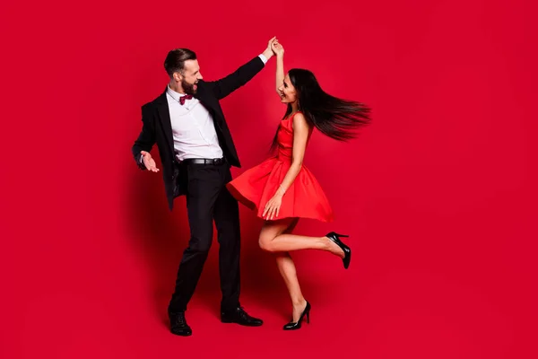 Full length photo of two positive persons dancing have great time isolated on red color background — Stock Photo, Image