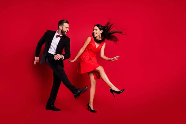 Foto de perfil de tamanho completo de casal funky dança desgaste vestido vívido terno preto isolado no fundo de cor vermelha — Fotografia de Stock