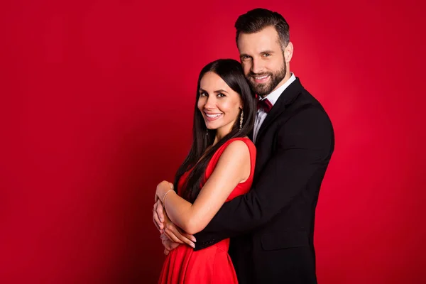 Profile photo of optimistic couple wear vivid dress black suit isolated on red color background — Stock Photo, Image