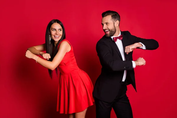 Portrait of positive attractive lady handsome guy excited dancing good mood isolated on red color background — Stock Photo, Image
