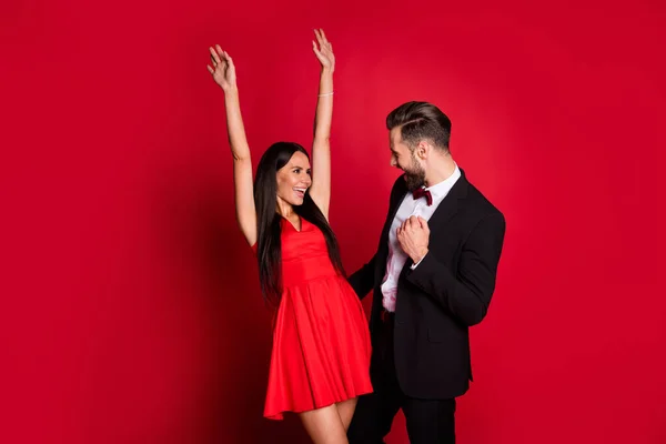Photo of cute optimistic couple dancing wear suit dress isolated on red color background — Stock Photo, Image