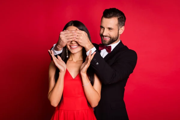 Foto de pareja agradable hombre cerrar los ojos de la muchacha usan traje vestido aislado sobre fondo de color rojo — Foto de Stock