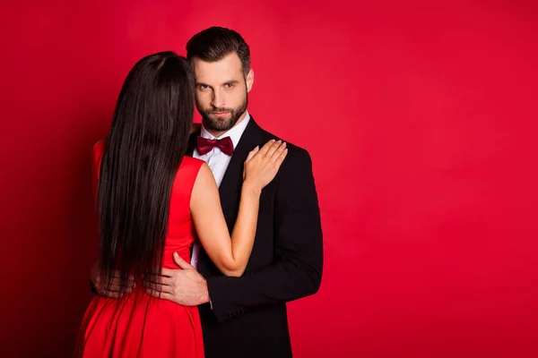 Photo of optimistic couple dance near empty space wear suit dress isolated on red color background