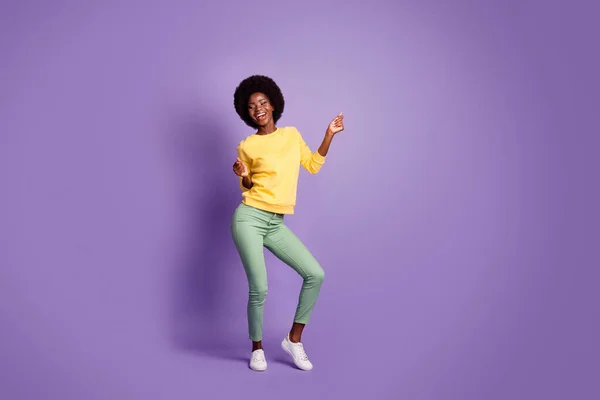 Full length photo of lovely girl look empty space dancing wear yellow pullover isolated violet color background — Stock Photo, Image