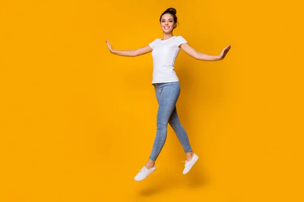 Full length body size view of her she nice-looking attractive lovely pretty winsome cheerful cheery girl jumping walking isolated over bright vivid shine vibrant yellow color background — Stock Photo, Image
