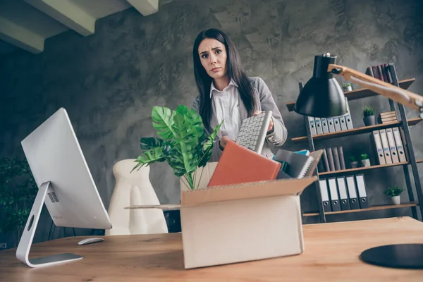 Low angle view photo of frustrated girl collar put keyboard in cardboard box quit office marketer occupation company crisis bankropt wear blazer jacket suit in workplace workstation — Stock fotografie