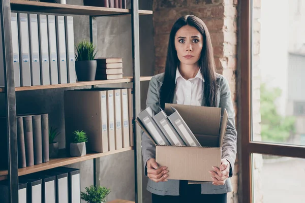 Photo of shocked frustrated girl lawyer representative lose her job dont know how live coronavirus crisis hold cardboard box wear blazer jacket suit in workplace workstation — ストック写真